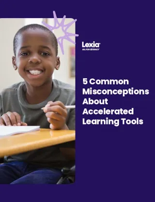 Smiling boy writing at a school desk next to text: 5 Common Misconceptions About Accelerated Learning Tools.