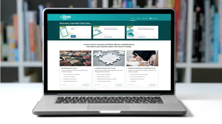 Laptop displaying an educational website with...