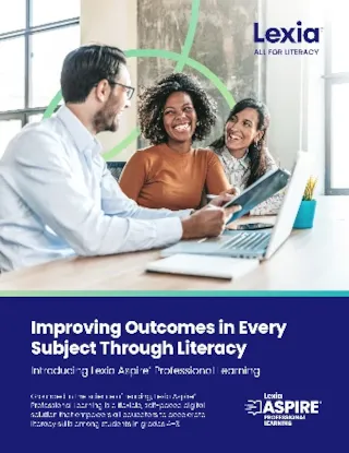 Three people sit and smile around a table with a laptop, paper, and coffee cup in a bright, modern office space.