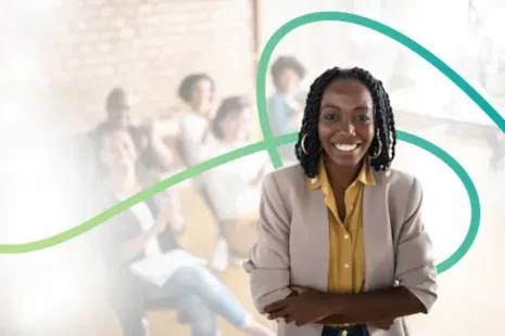 Smiling woman in a blazer stands confidently with arms crossed in front of a blurred group of people and abstract lines.