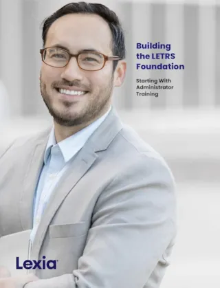 A smiling man in glasses and a light blazer stands next to text that reads, Building the LETRS Foundation.