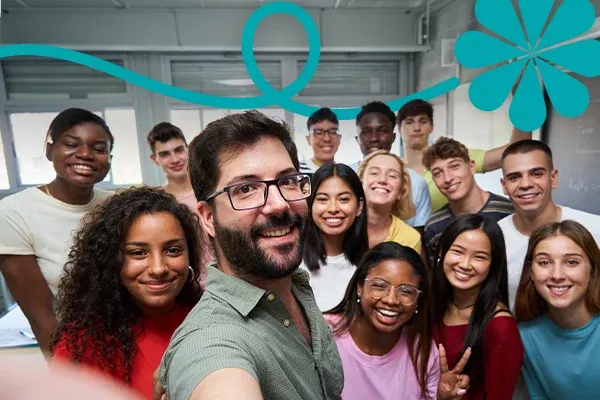 A group of diverse students and a teacher smile together for a selfie in a classroom with abstract blue graphics.