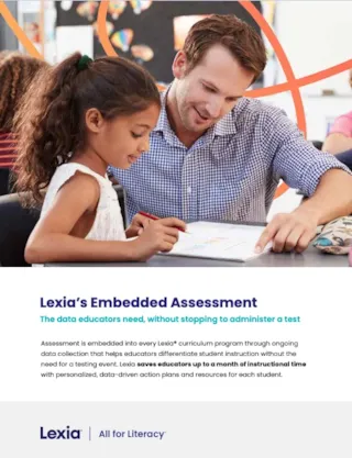 A teacher helping a young student with her schoolwork.