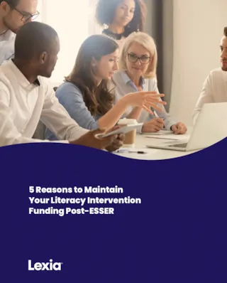 A group of professionals having a meeting in a conference room, discussing literacy intervention funding.