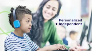 A boy wearing blue and grey headphones uses a computer with a teacher nearby, next to the text Personalized + Independent.