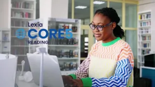 A woman sits at a desk in a library, using a laptop. Text reads Lexia Core5 Reading.