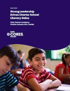 Smiling boy in a red striped shirt sits at a desk in a classroom with other students, text about literacy gains above.