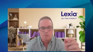 A man with glasses speaks in front of a background with a Lexia All For Literacy logo.