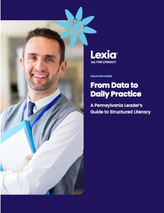 Smiling man holding folders stands next to Lexia: From Data to Daily Practice guide on structured literacy.