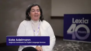 Woman with shoulder-length gray hair sits indoors; a sign reads 40 Years. Text: Kate Adelmann, Regional Coordinator.