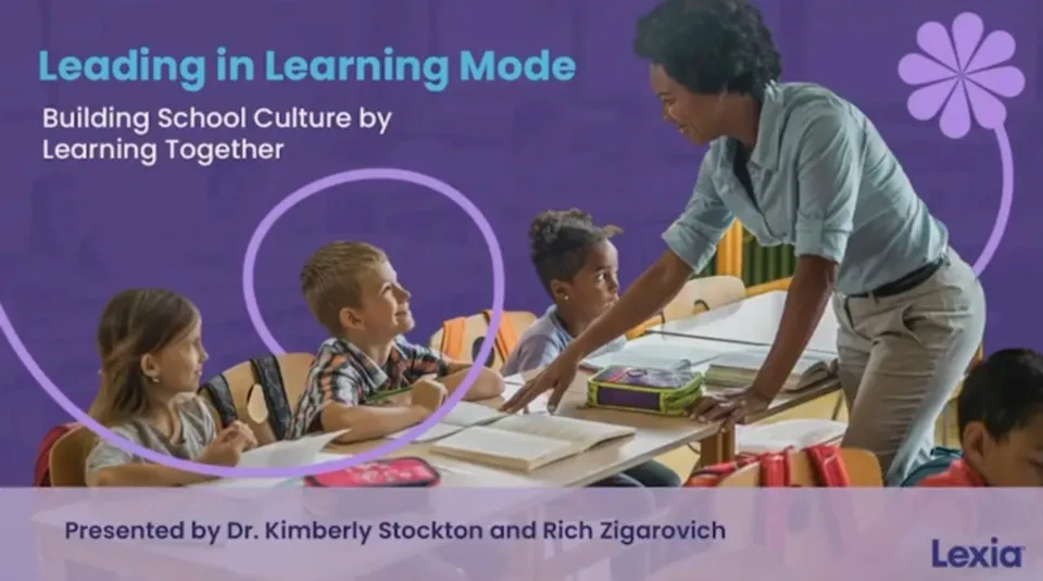 Teacher smiling and talking to diverse young students in a classroom, with Leading in Learning Mode text overlay.