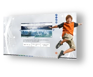 Smiling boy jumps in front of a large interactive screen displaying a glacier and quiz options.