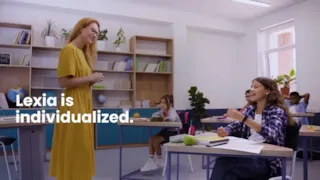A teacher stands by a student’s desk, smiling, while other students sit at desks in a classroom. Text reads, Lexia is individualized.