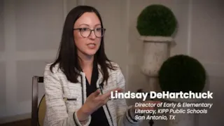 A woman with glasses speaks in an interview setting; text reads Lindsay DeHartchuck, Director, KIPP Public Schools, San Antonio, TX.