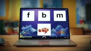 A laptop screen shows a childrens game matching a clownfish image with the letters f, b, or m.