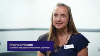 Smiling woman in a blue shirt sits in front of a white background. Text reads Rhonda Nelson, Curriculum Instruction and Assessment Coordinator.